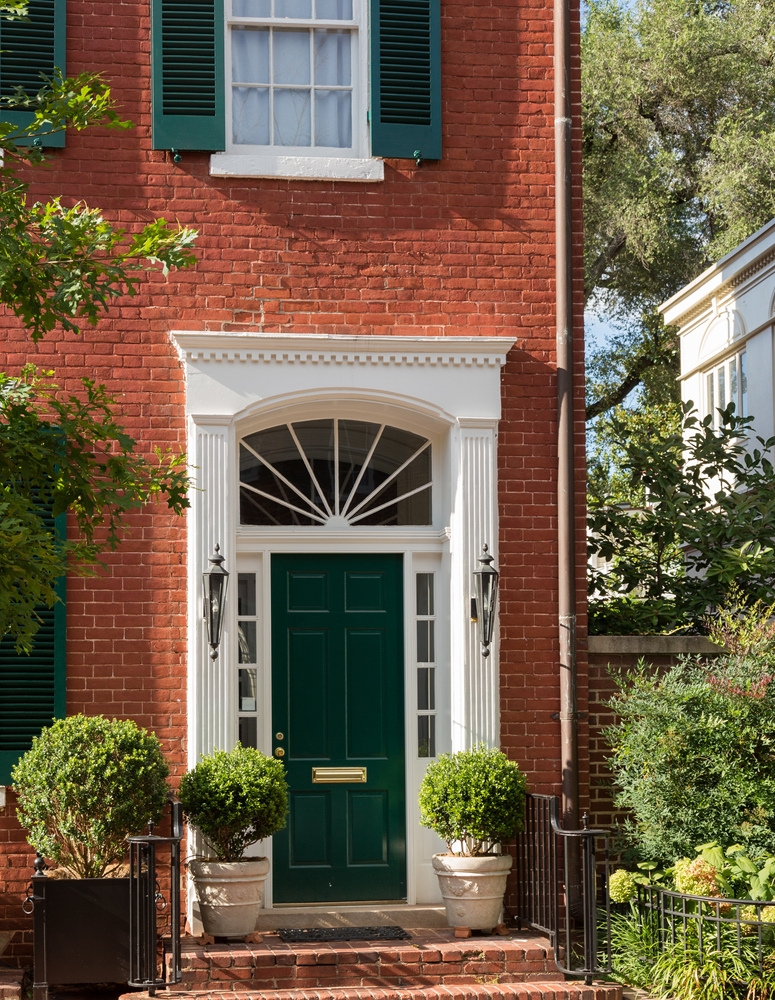 Front door of one of the brick townhouses where the Kennedys had lived with potted plants.