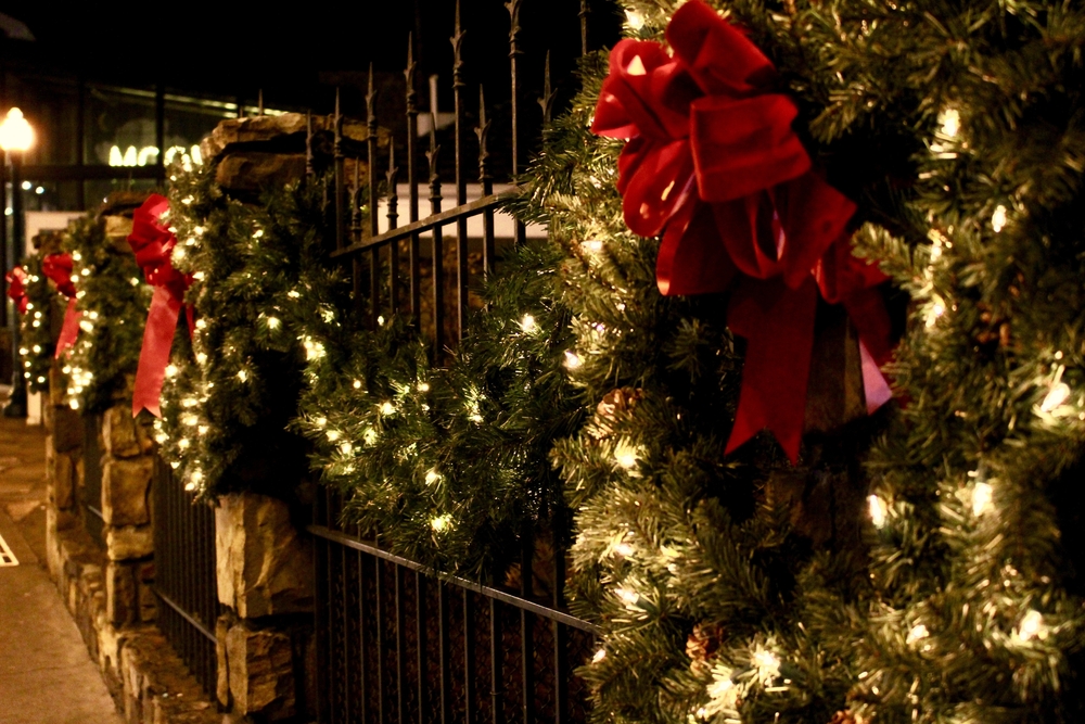 christmas wreaths and garlands with bows and christmas lights