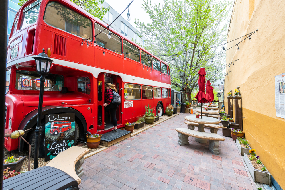 The outside of Double D's coffee shop which is a London double decker bus with a patio outside