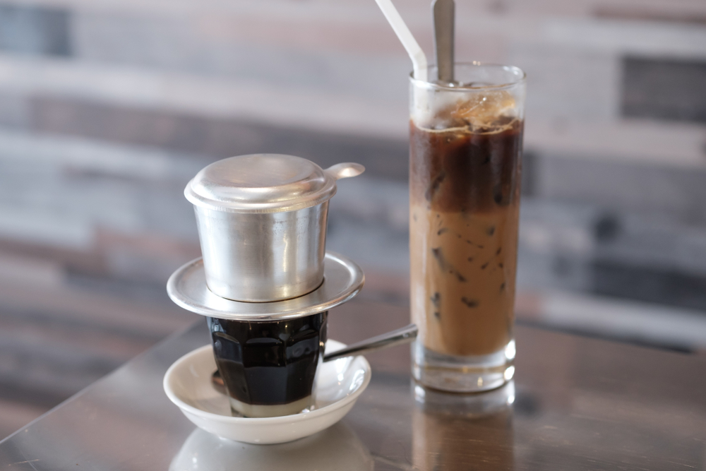 A Vietnamese coffee in a glass and a small coffee next to it.