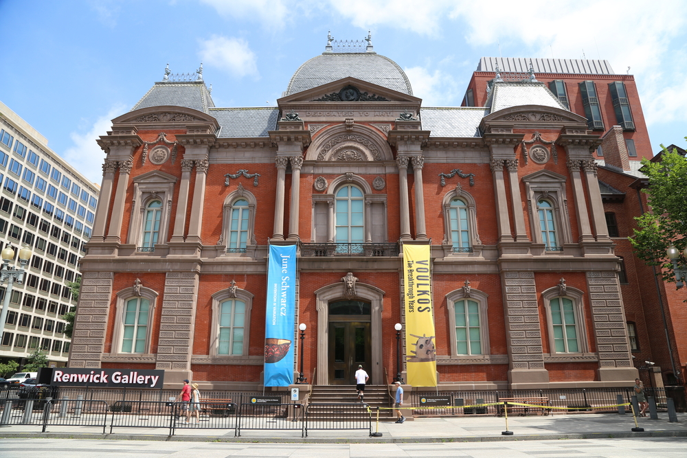 The exterior of the Renwick Gallery, one of the Smithsonian art galleries. It is a large brick building with columns, multiple windows, and ornate decorations. 