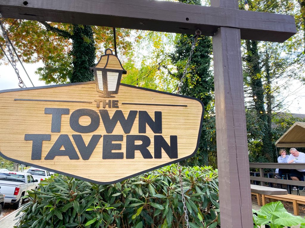 The Town Tavern is one of the restaurants In Blowing Rock shown here with tis wooden sing