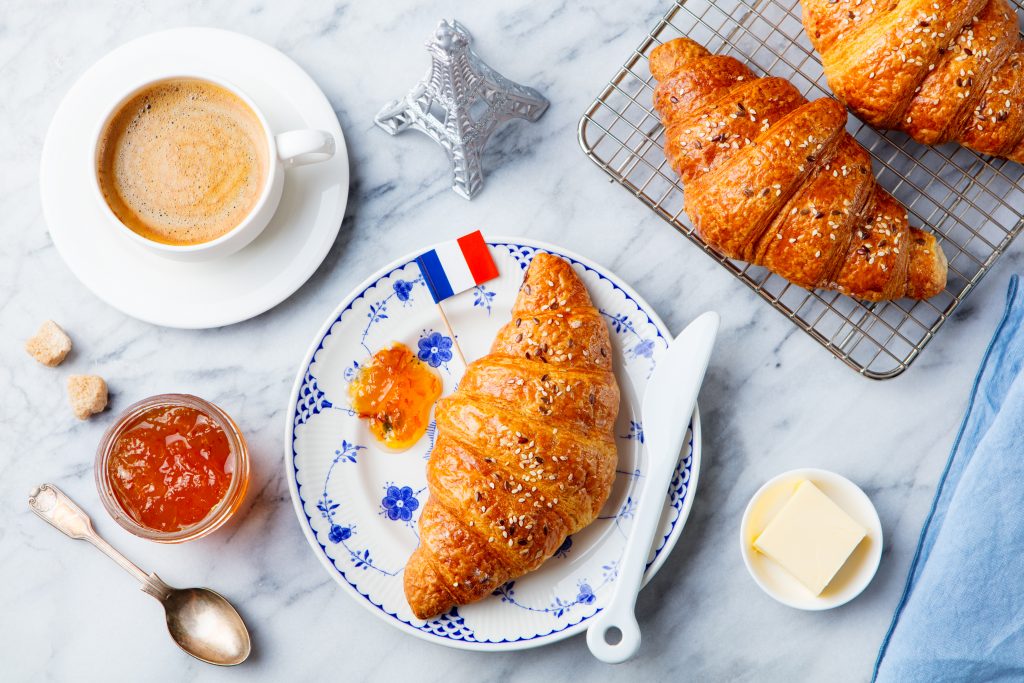 croissant on plate with French flag, jam, butter, coffee cup restaurants in Richmond