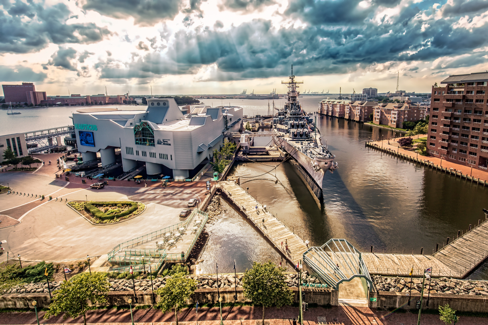 Aerial view of the Nauticus and a battleship in the harbor at Norfolk.