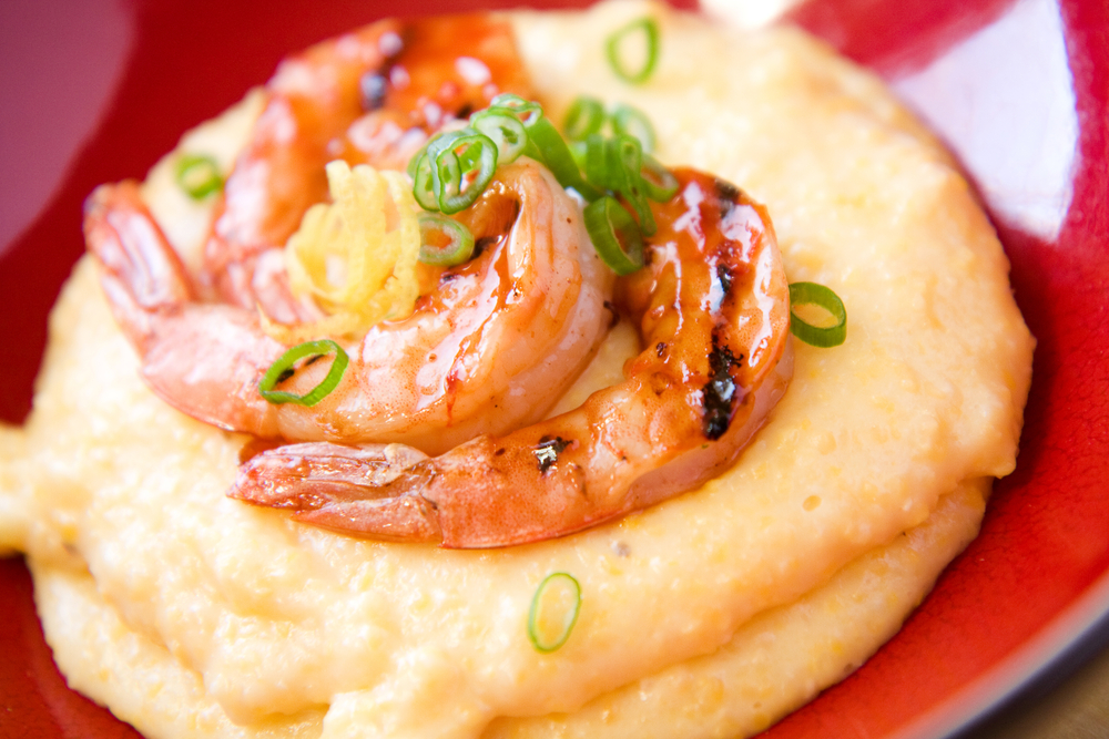 Several shrimp with scallions on top of cheesy grits, like the dish served at The Local, one of the best restaurants in Boone, NC.