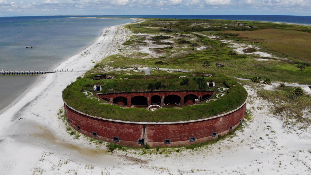 Aerial view of round Fort Massachusetts on the sandy beach of Ship Island, one of the best things to do in Mississippi.
