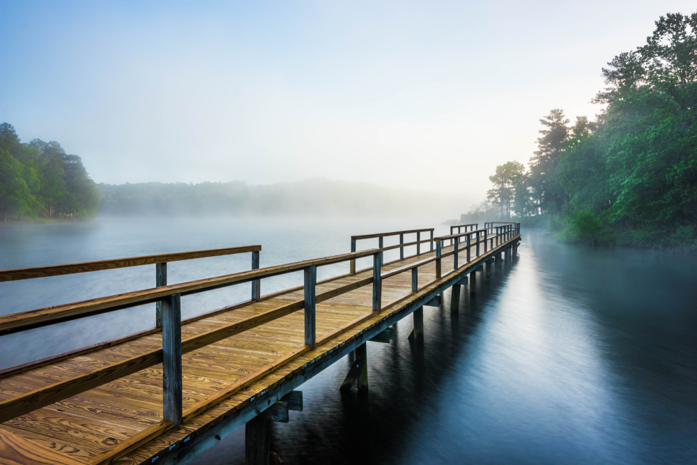 A pier stretching into a foggy lake at Tishomingo State Park.