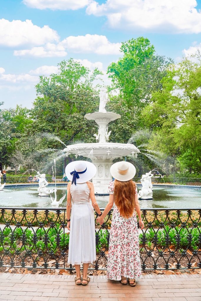 Two women stood in front of a fountain in an article about the best tours in Savannah