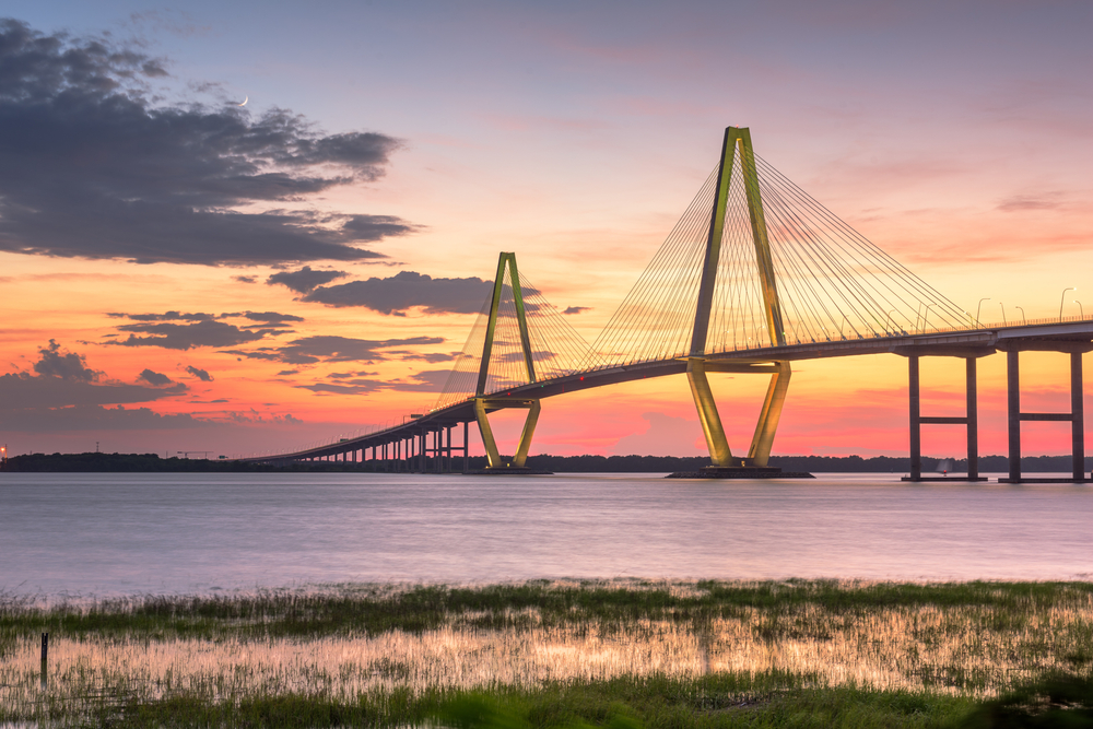 Ravenel Bridge stretching across the harbor at sunset, one of the best places to visit in Charleston.