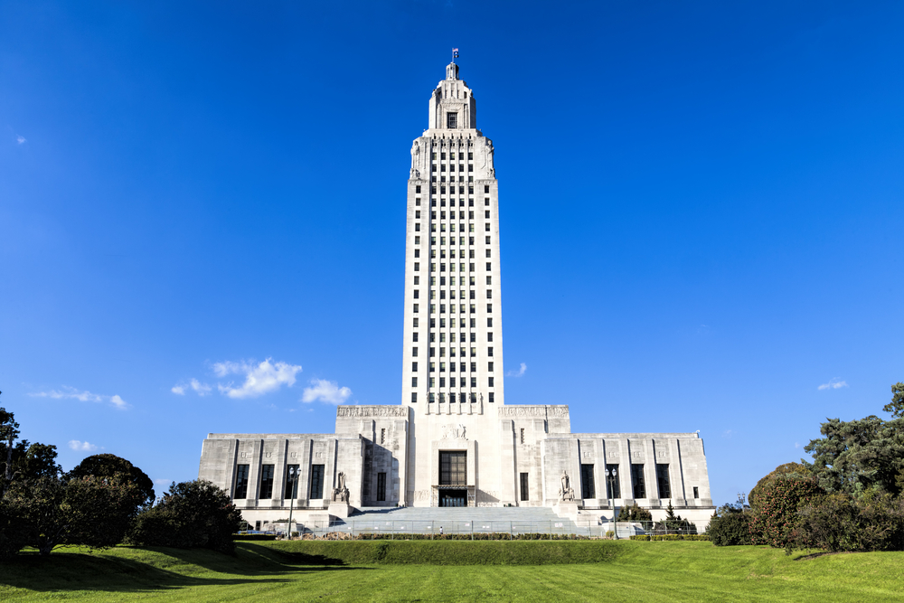 The 34-story Louisiana State Capitol Building surrounded by grassy grounds in Baton Rouge, one of the best places to visit in Louisiana.