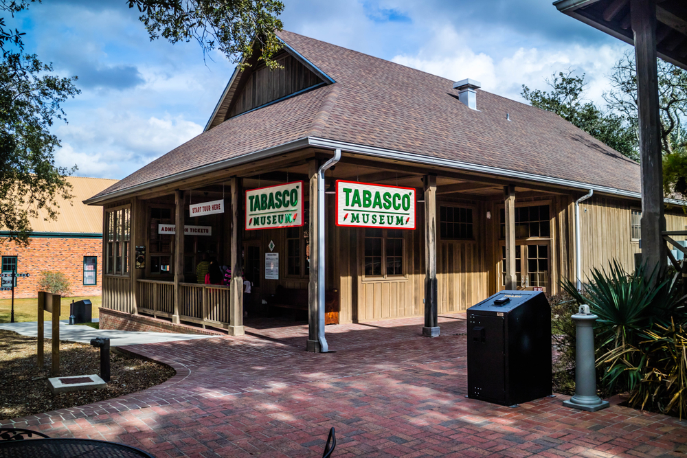 The single-story cabin that holds the Tabasco hot sauce museum on Avery Island, one of the best things to do in Louisiana.
