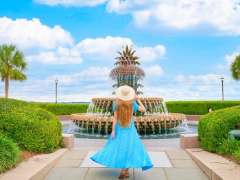 A girl at the Waterfront Park next to the Pineapple Fountain, one of the best places to visit in Charleston, SC.