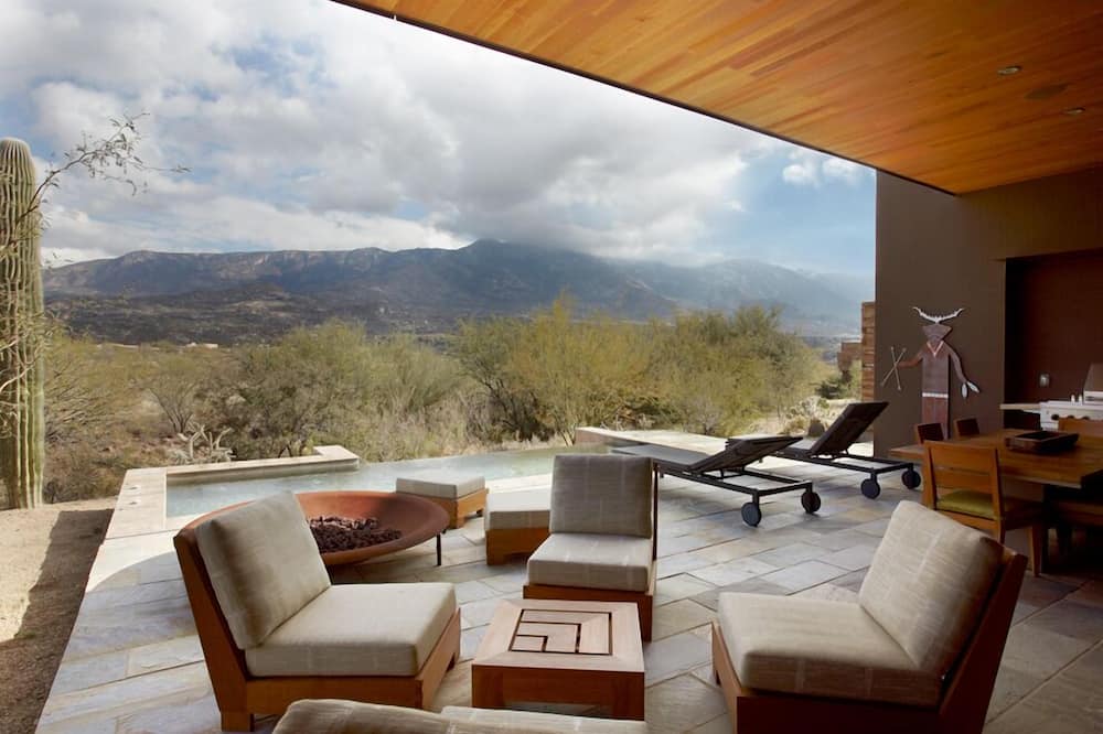 The outdoor space at miraval resort complete with view of the mountains from outdoor terrae with hot tub, and chairs and fire pit
