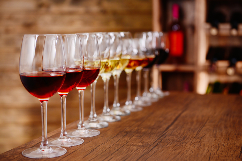 Wine glasses set up for a wine tasting on a wooden table