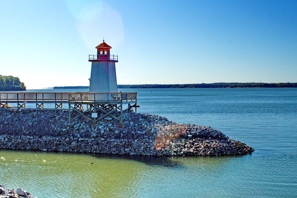 small lighthouse on jetty near water