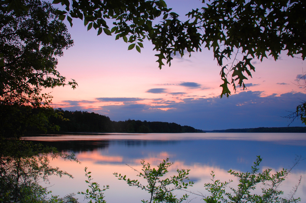 beautiful Jordan lake surrounded by trees and foliage at sunset