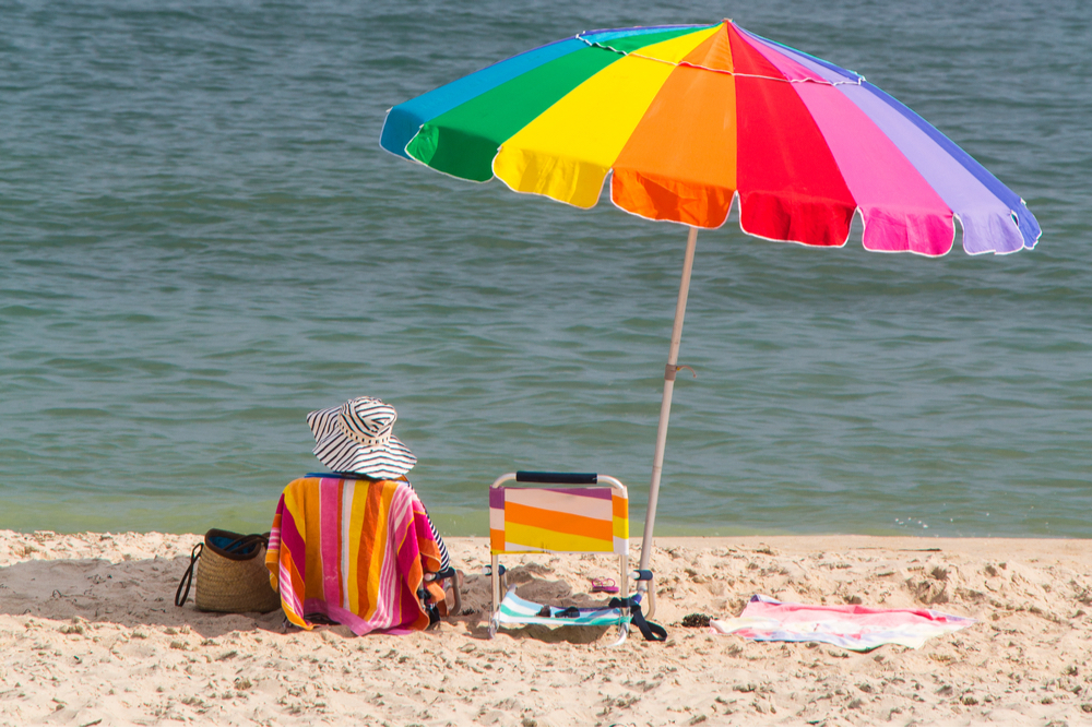 Sitting under colorful umbrella at Lake Charles North Beaches in Louisiana 