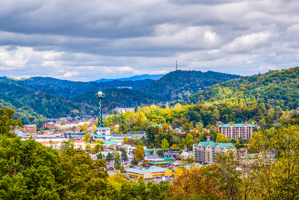 Looking down into Gatlinburg nestled among fall trees and mountains.