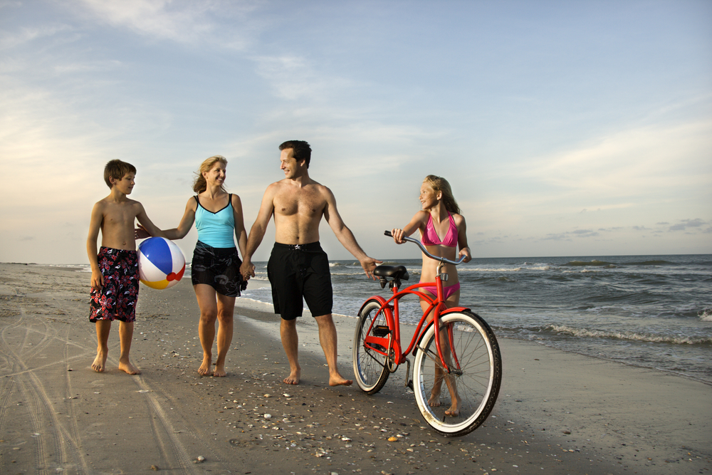 Family walks along the beaches in North Carolina. 