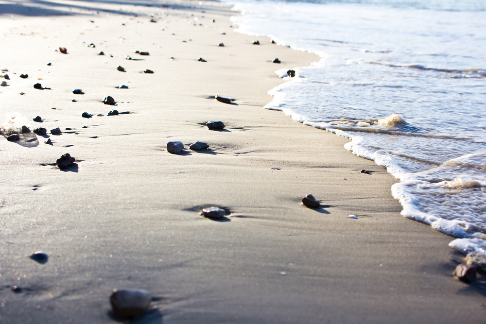 Beach with small stones and waves crashing