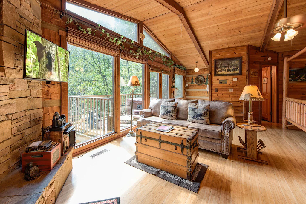 The inside of a log cabin with beautiful huge windows and a great view outside.  One of the cabins in Tennessee to stay in. 