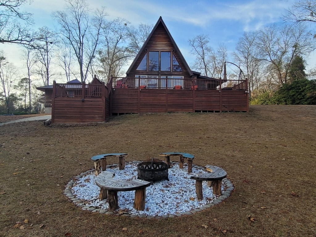 a-frame cabin with fire pit in front yard