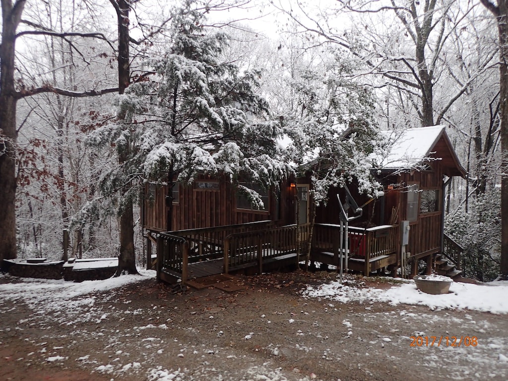 small cabin with front porch in the snow