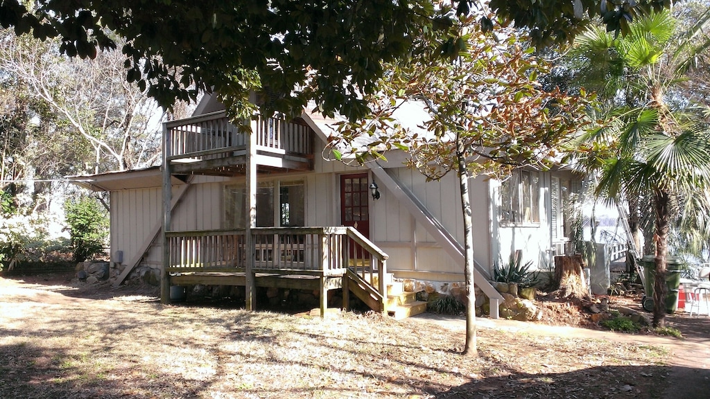 two story cabin with palm tree next to it