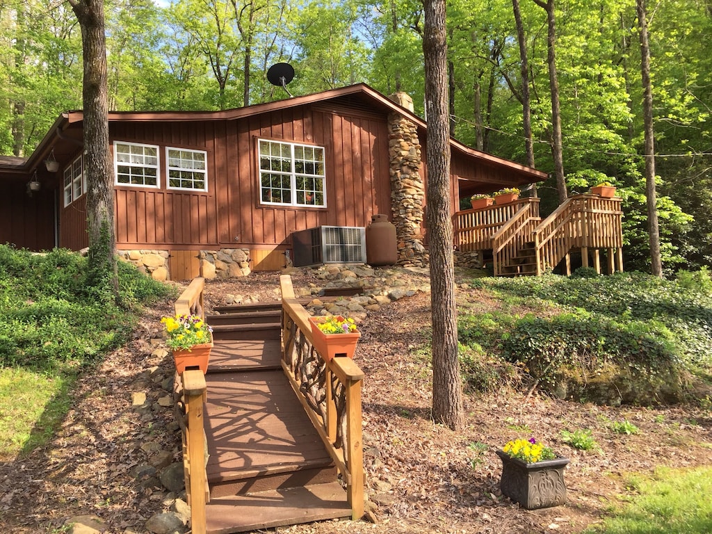 wooden pathway leading up to cabin in the woods