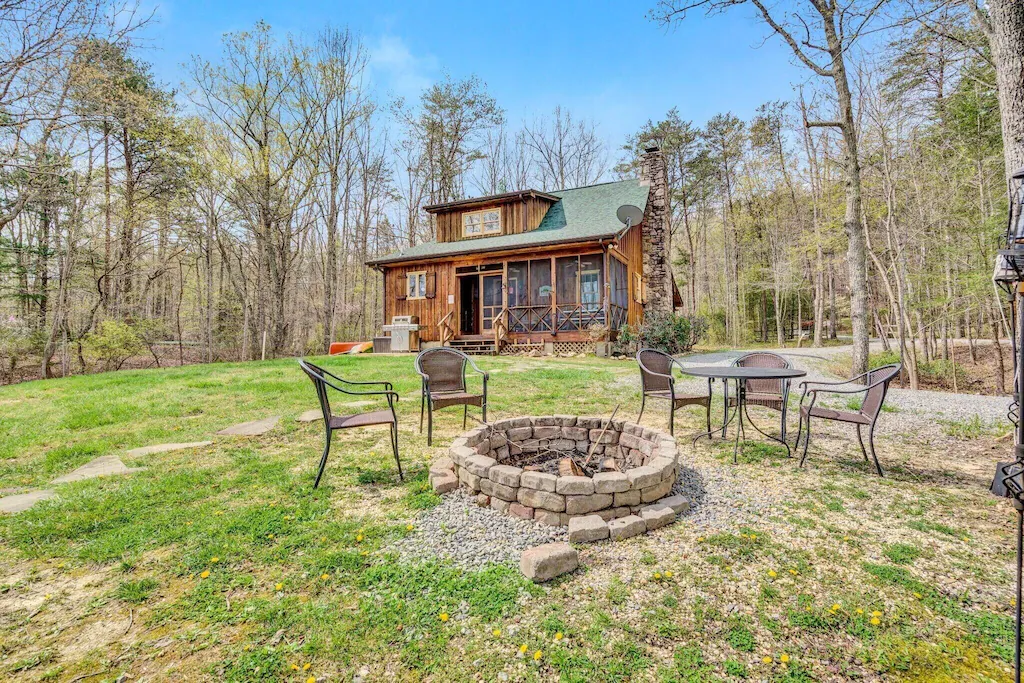 fire pit and outdoor seating in front of little cabin