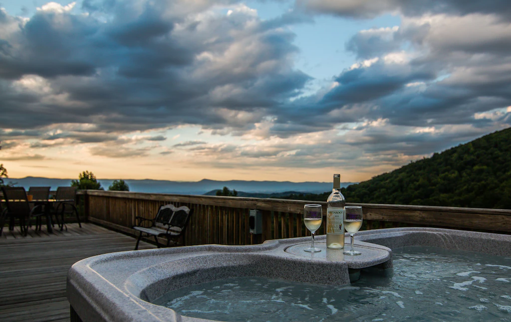 hot tub on deck overlooking mountains and valleys
