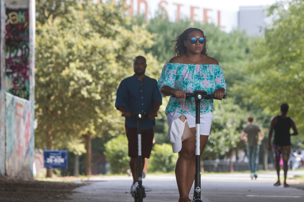 A couple rides through downtown on segways, enjoying a date night in Atlanta.