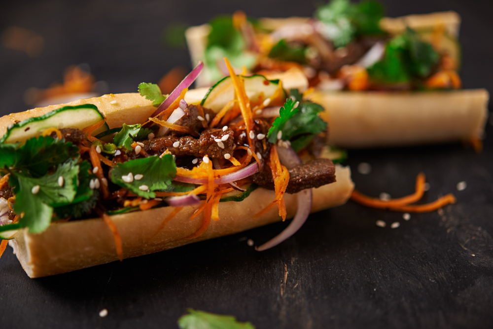 A Banh Mi sandwich with meat and vegetables. 