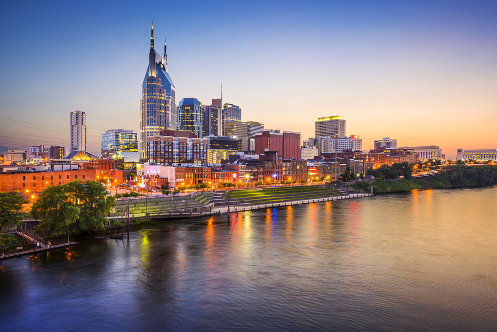 Downtown in Nashville with a view of the buildings across the river in an article about restaurants in Nashville. 