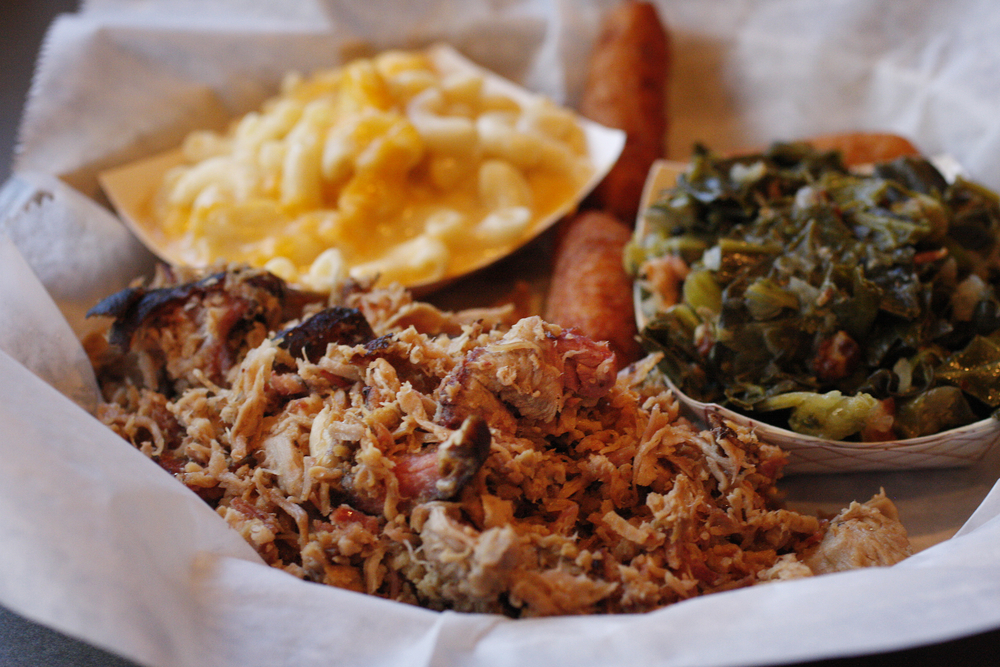 barbecue, mac and cheese, and greens in a tray