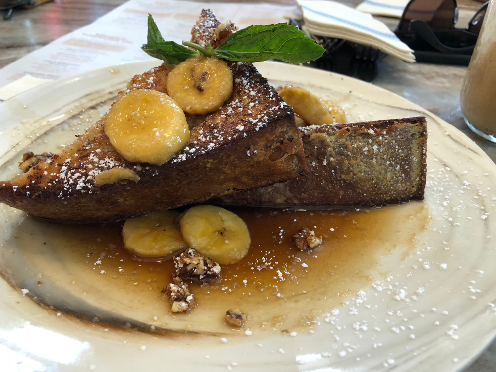 Slices of banana top this Banana Foster French Toast, which is one of the most-loved orders for breakfast in Pigeon Forge at Sawyer's Farmhouse Restaurant.