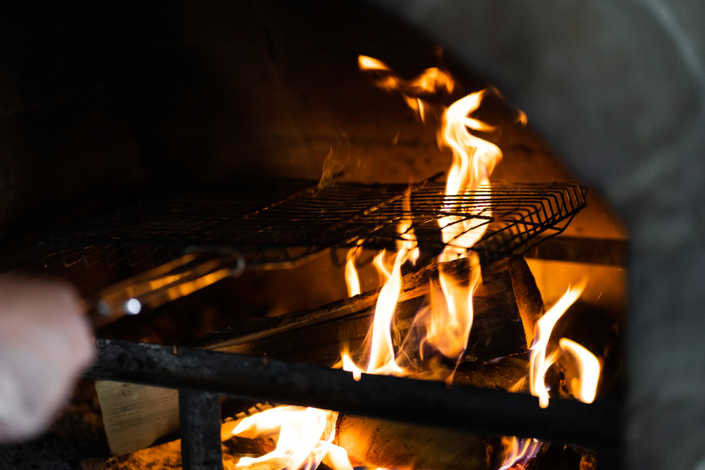 One of the most delicious places to eat in Greensboro is Sticks & Stones. They use a clay oven, which is shown here with flames coming up.