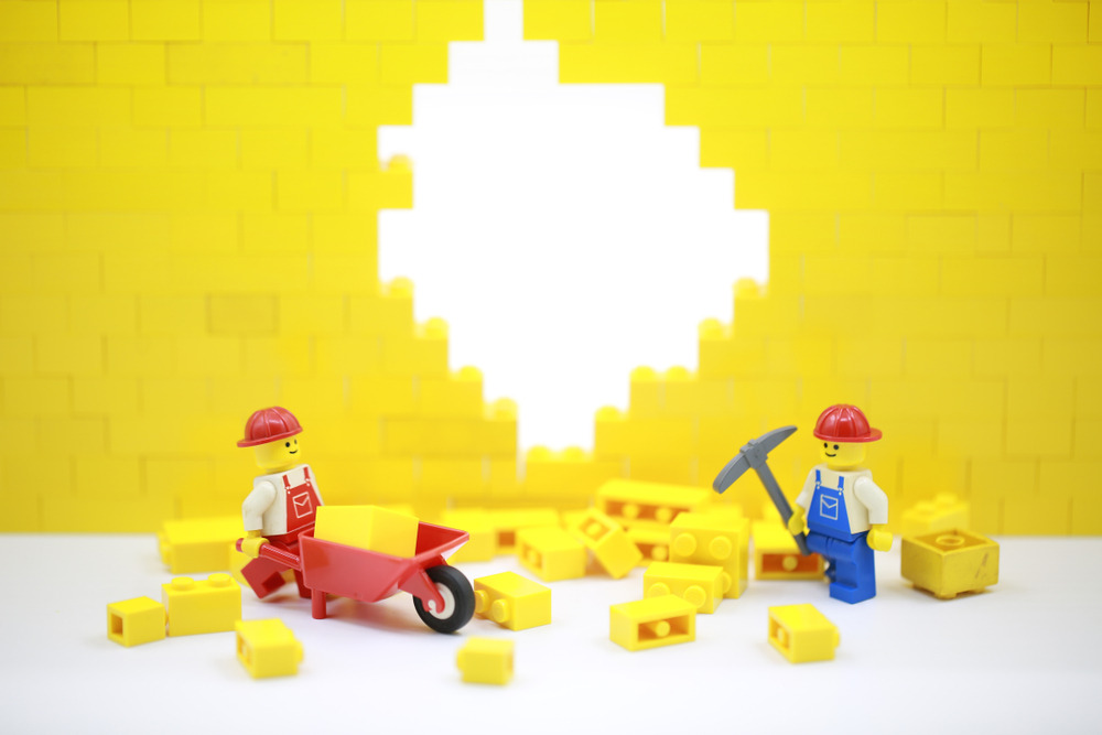 Two Lego men moving Lego blocks on a Lego construction site made of Legos at one of the Legoland theme parks in Georgia. 