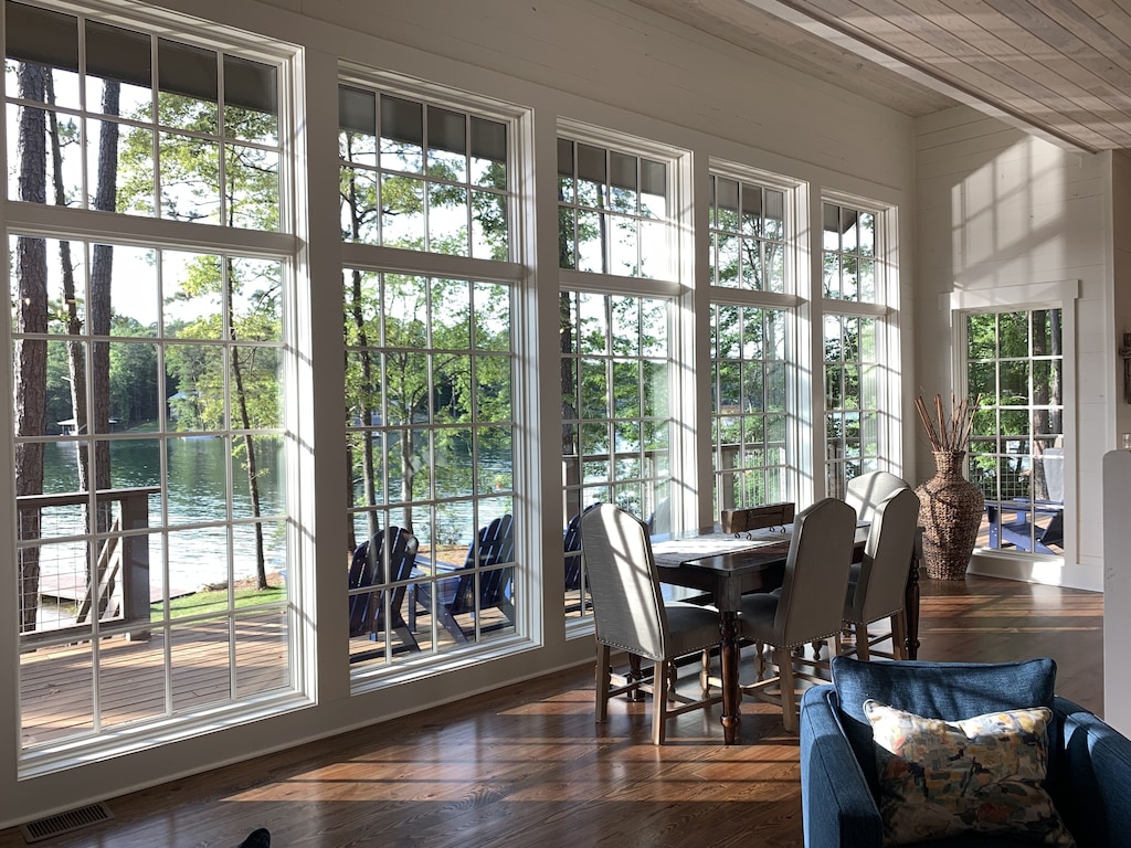 The view of the beautiful green blue water of Lake Martin out the window of the Lake Martin escape Airbnb, one of the best airbnbs in Alabama 