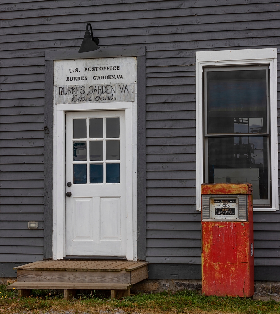 A small old post office with an old gas pump outside of it in a small town in Virginia. 