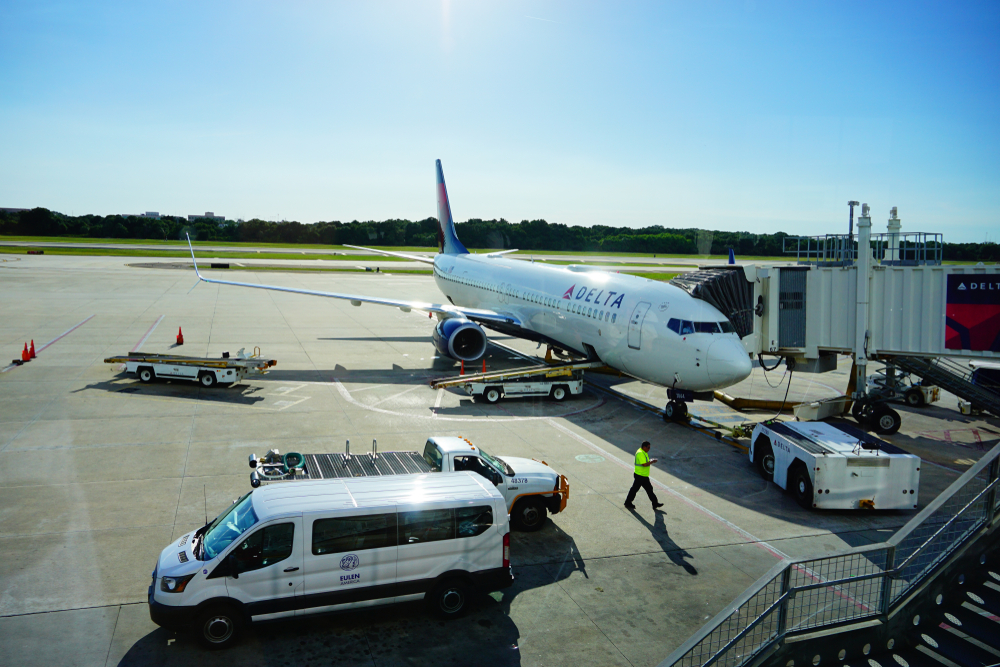 A Delta Airlines plane on the tarmac at an airport. 