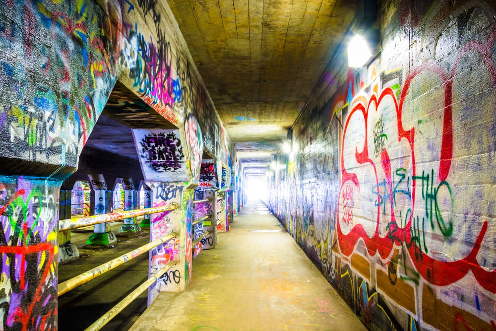 Looking down the pathway of the Krog Street Tunnel in Atlanta that is covered in graffiti. 