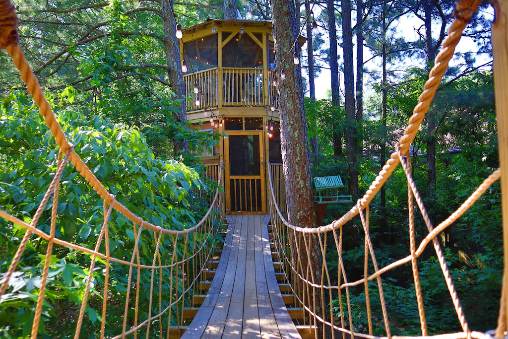 Photo of the rope bridge to Treasure Hunt Treehouse, one of the best luxury treehouse rentals in Georgia.