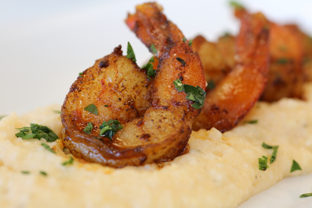 Shrimp on top of cheesy grits, one of the most popular foods for breakfast in Charleston, SC.