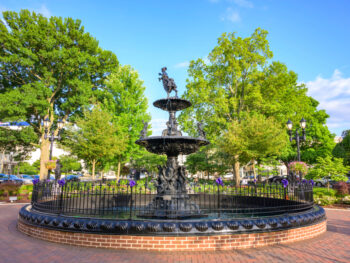a lovely fountain surrounded by green trees in a square at bowling green kentucky