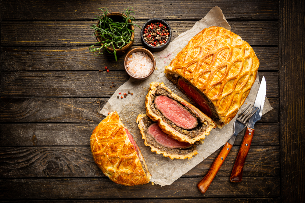 photo of beef Wellington on a wood table with two slices from one of the best restaurants in Memphis 