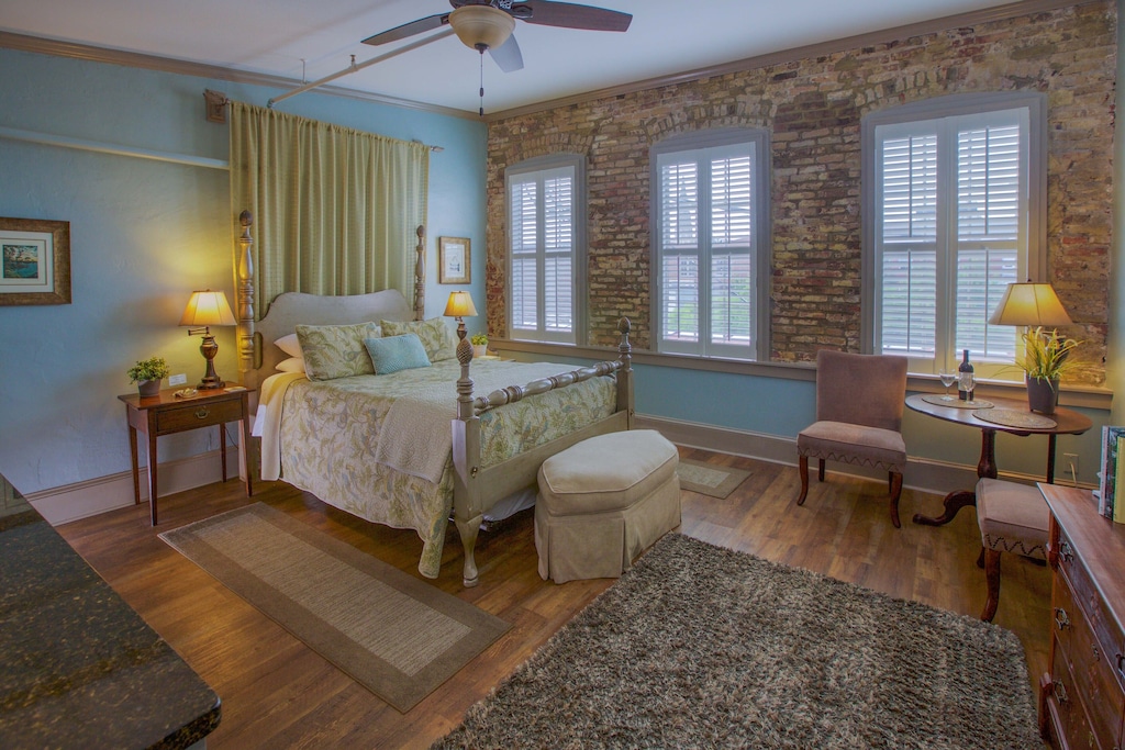 View of the exposed brick and antique furnishings of the historic downtown studio 