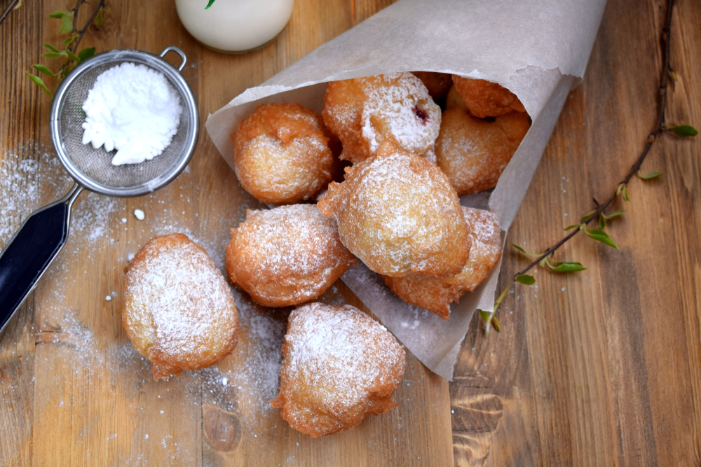 Powdered covered beignets fall onto the table at one of the  best restaurants in San Antonio.