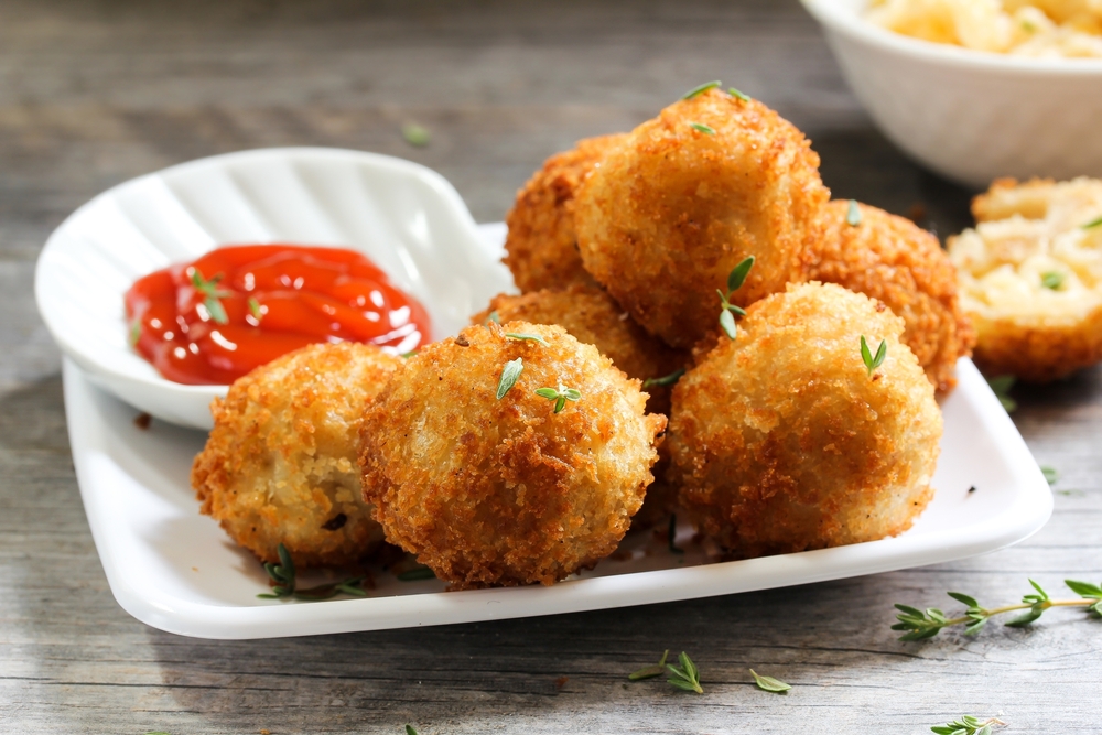 Deep fried mac and cheese balls on this plate are a part of southern comfort cuisine and you can find this starter at many of the best restaurants in San Antonio.