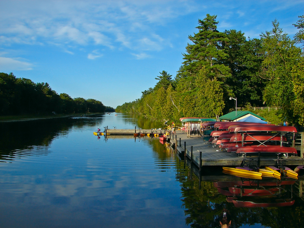 rack of canoes on smooth water with blue skies in lakes in georgia